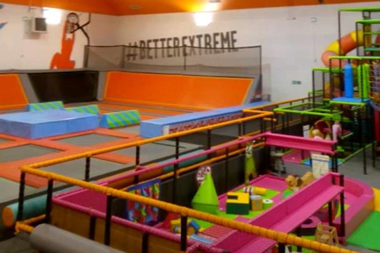 Photo of Newcastle Trampoline Park showing a large space with trampolines and a soft play area 