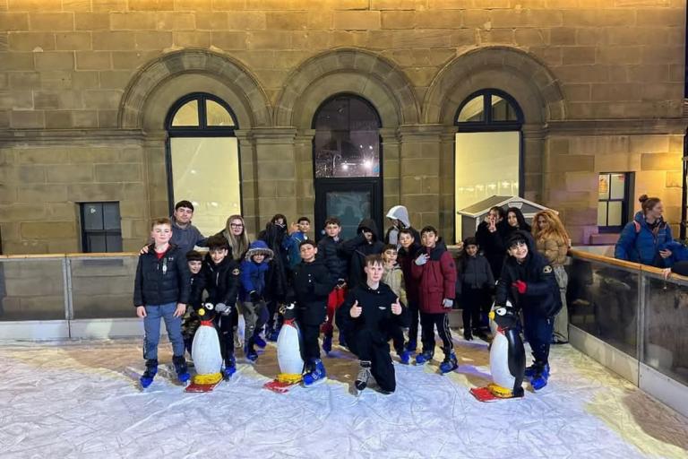 Group of young people ice skating 