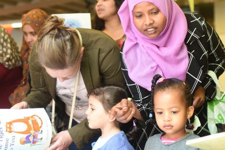 Mother_and_kids_looking_at_books