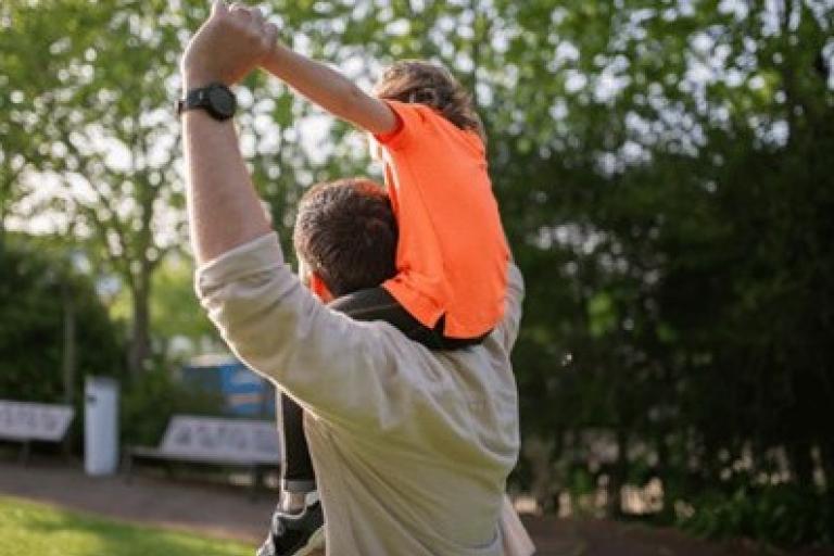 Child on dad's shoulders