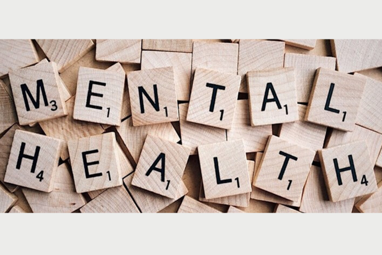 Wooden scrabble letters spelling out the words mental health 