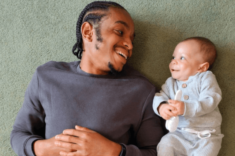 Dad and baby smiling at each other