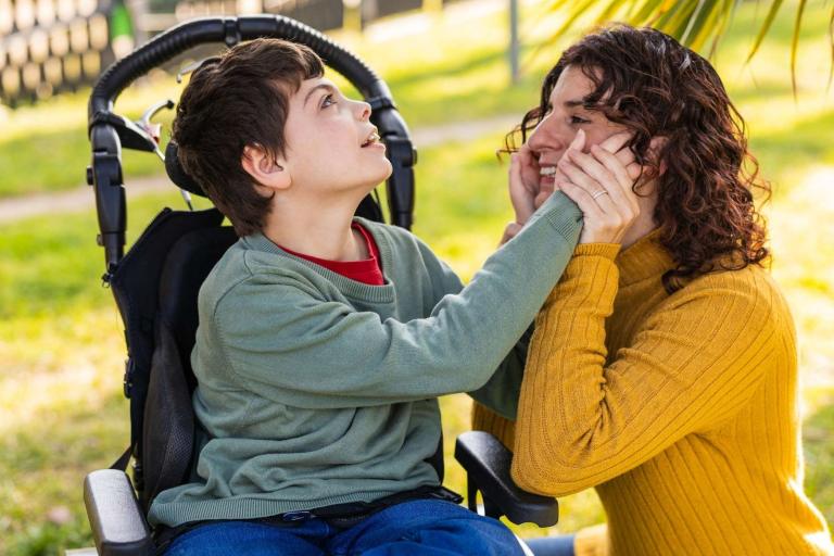Child in wheelchair with female carer 