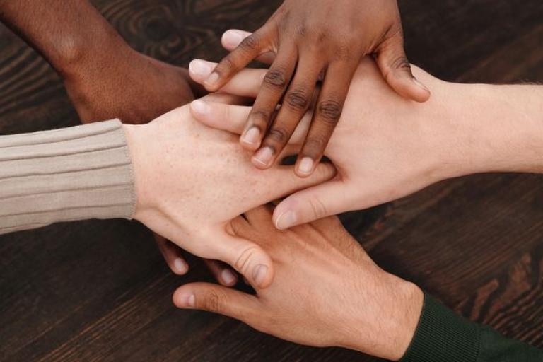 Hands on top of one another 