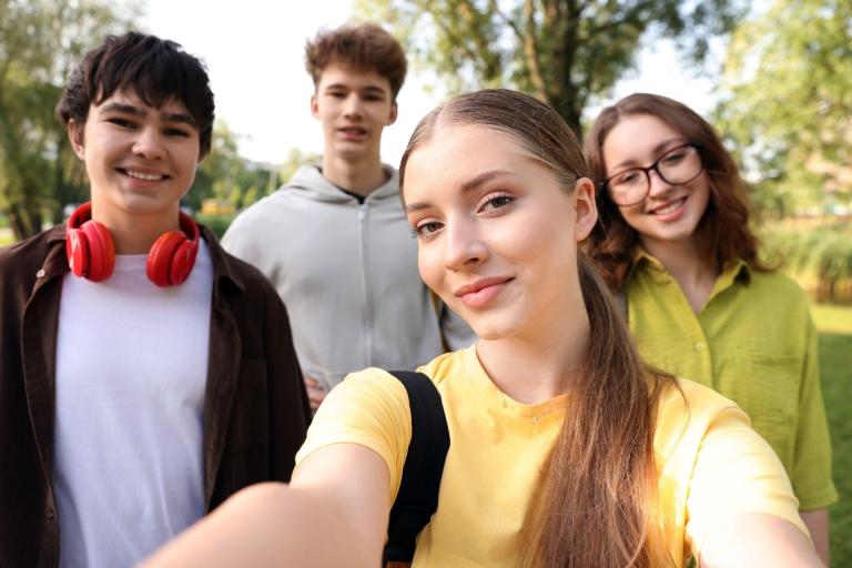 Group of 4 teenagers taking a selfie photograph
