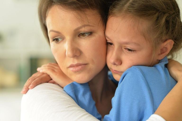 Carer comforting distressed child