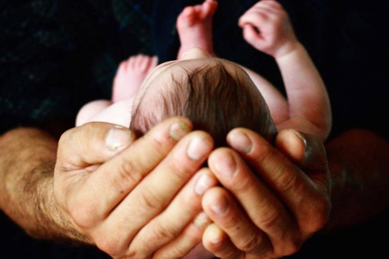 Newborn in dad's hands