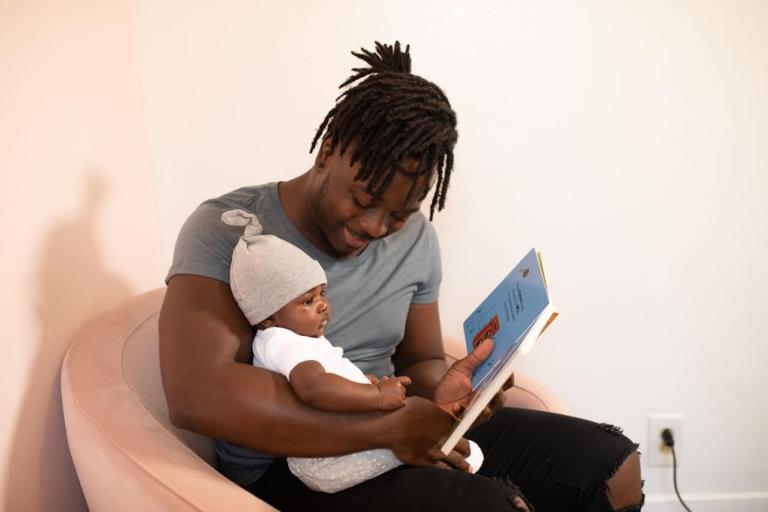 Dad reading to baby
